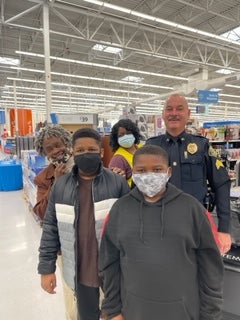 image of a cop posing with a family