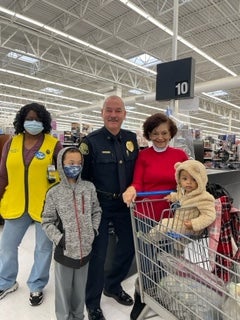 image of a cop posing with a family
