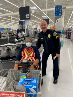 image of a cop posing with an elderly woman