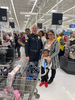 image of a cop posing with a family