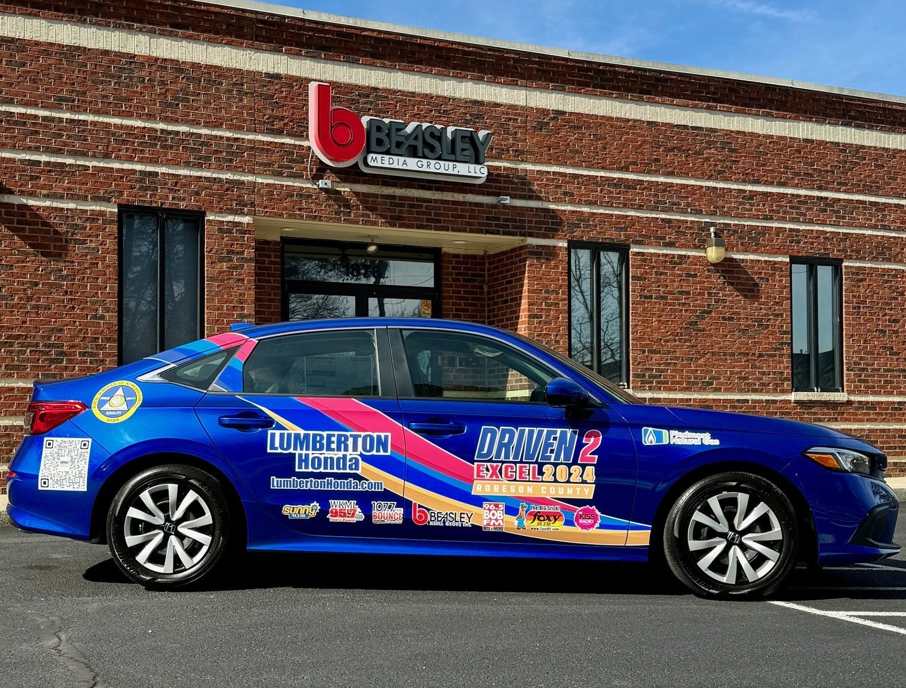 a blue car in front of Beasley shop