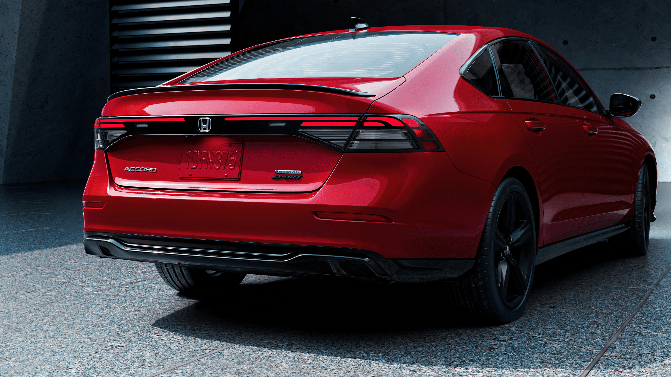 Rear view of the 2024 Honda Accord Hybrid Sport in striking red finish.