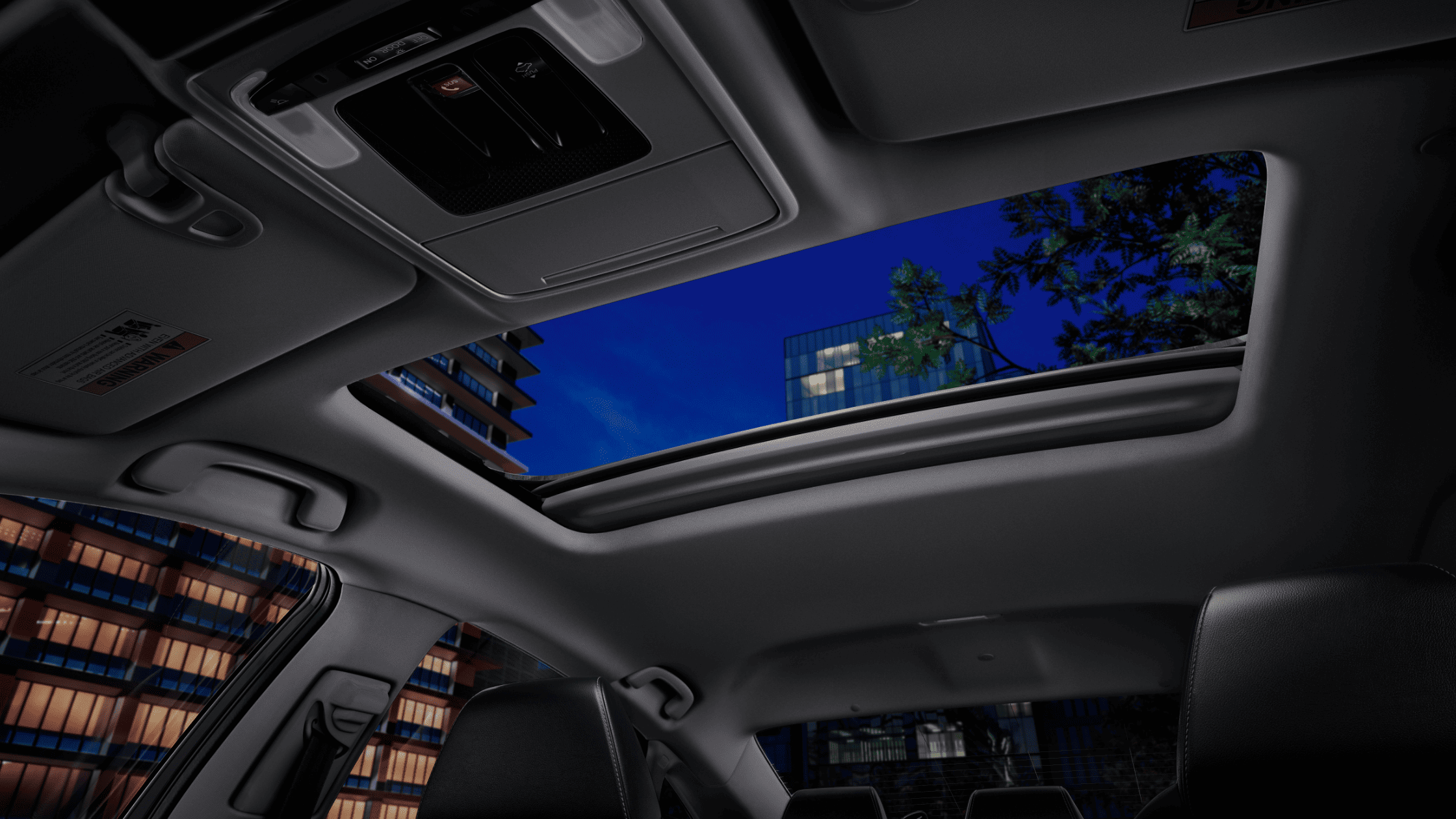 2024 Honda Accord Sedan interior with open moonroof and nighttime city view.
