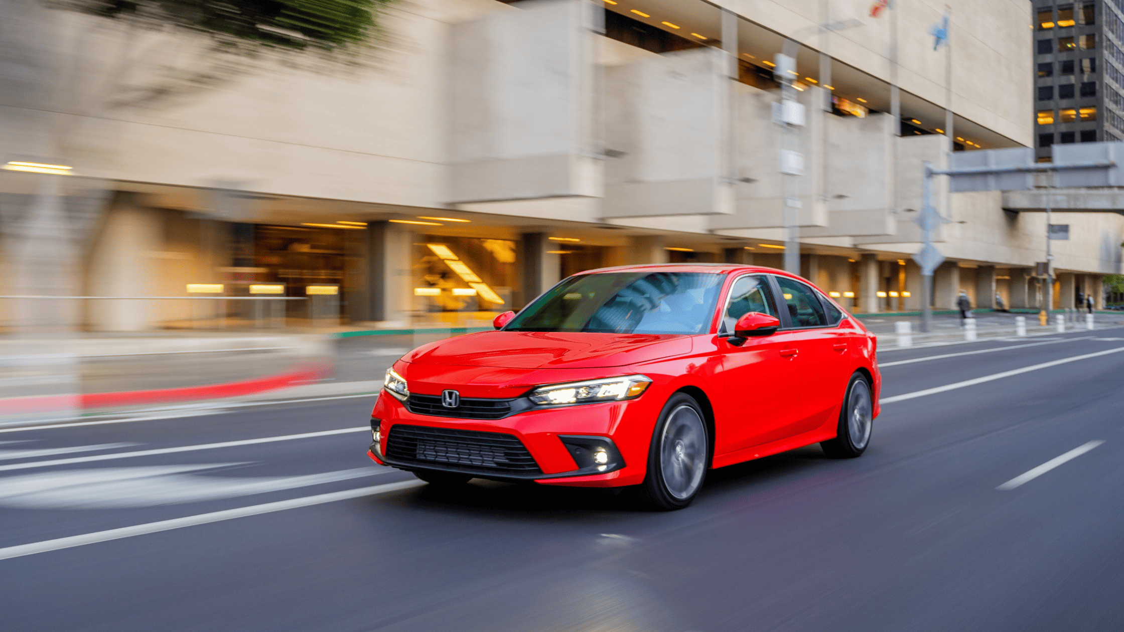 Red 2024 Honda Civic Sedan with nature background.